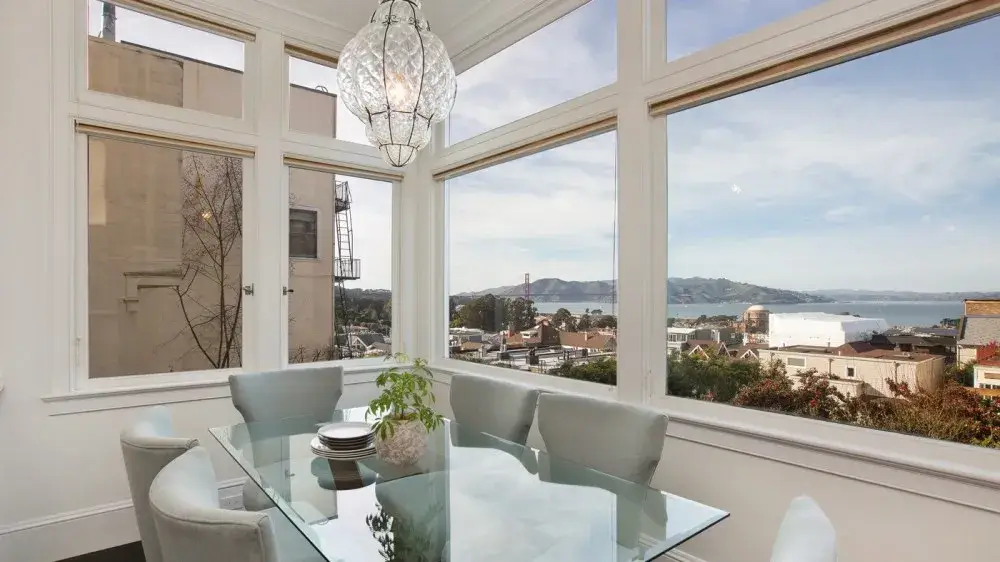 A modern living room with a view of the Golden Gate Bridge, symbolizing the impact of mortgage rates on the Bay Area real estate market, including trends in interest rates, refinancing, and investment opportunities.